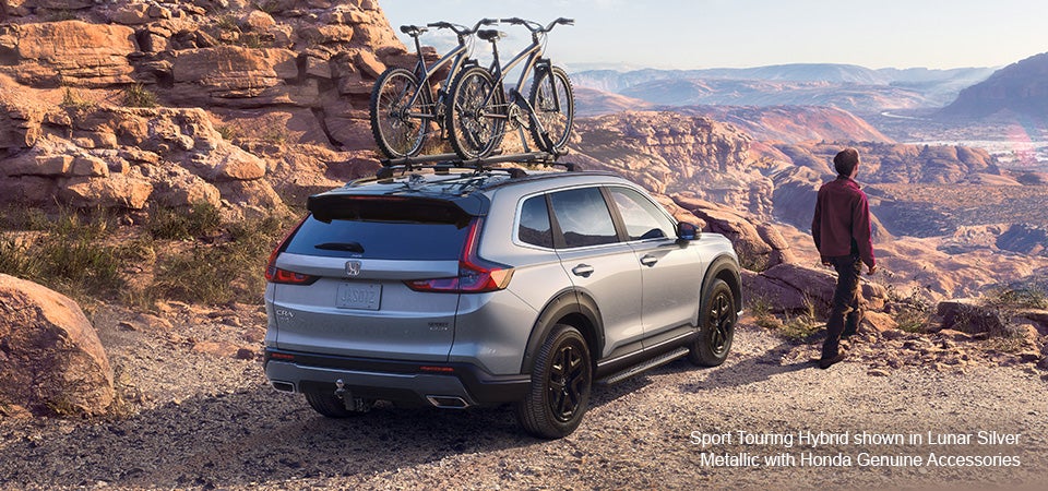 2023 Honda CRV parked on cliff ridge with bikes secured to roof rack
